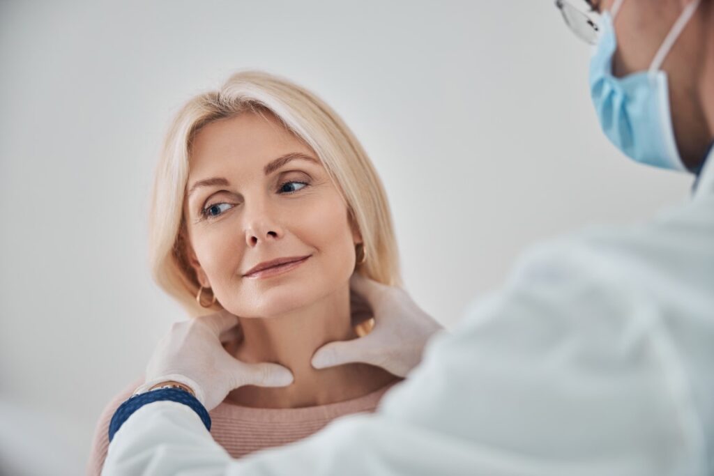 Médecin palpant la thyroïde